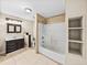 Bathroom featuring a shower-tub combo with tile surround, a single vanity, and tiled floors at 4230 Viola Rd, Lakeland, FL 33810