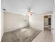 Bedroom featuring neutral paint, a ceiling fan, and access to an adjacent bathroom at 4230 Viola Rd, Lakeland, FL 33810