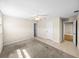 Bedroom with carpet, a ceiling fan, and access to an adjacent bathroom at 4230 Viola Rd, Lakeland, FL 33810