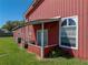 Close up view of the exterior featuring a covered porch and well-manicured lawn at 4230 Viola Rd, Lakeland, FL 33810