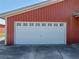 Photo of a white garage door with upper window panels on a red metal building at 4230 Viola Rd, Lakeland, FL 33810