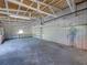 View of the large interior of a metal garage with white walls, ceiling and concrete floor at 4230 Viola Rd, Lakeland, FL 33810