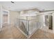 View of the second-floor hallway featuring carpeted floors, a staircase, and access to various rooms at 4230 Viola Rd, Lakeland, FL 33810