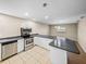 Open concept kitchen with stainless steel appliances and breakfast bar at 4230 Viola Rd, Lakeland, FL 33810