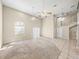 Open living space with high ceilings, ceiling fans, carpet, and tiled entry area at 4230 Viola Rd, Lakeland, FL 33810
