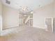 Open-concept living room with tile entry, carpeted area, high ceilings and an open staircase at 4230 Viola Rd, Lakeland, FL 33810