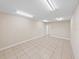 Bright room with tile flooring, white walls, and standard door leading to adjacent space at 4230 Viola Rd, Lakeland, FL 33810