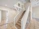 Carpeted staircase with a stone accent wall and white trim leading to the upper level at 4230 Viola Rd, Lakeland, FL 33810