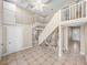 Staircase featuring stone accent, tile floor, and white banister, leading to the upper level at 4230 Viola Rd, Lakeland, FL 33810