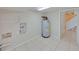 Utility room with tile floors and water heater, adjacent to a staircase and utility connections at 4230 Viola Rd, Lakeland, FL 33810