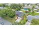 Home with lush landscaping, and a dark gray roof with a pool in a fenced in backyard at 4622 Grovecrest Dr, Lakeland, FL 33813