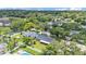 Aerial view of a home surrounded by lush greenery and a swimming pool at 4622 Grovecrest Dr, Lakeland, FL 33813