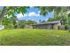 Backyard featuring mature trees and an enclosed patio at 4622 Grovecrest Dr, Lakeland, FL 33813