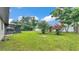 Large backyard with beautiful trees and an enclosed patio at 4622 Grovecrest Dr, Lakeland, FL 33813