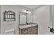 Bathroom featuring a granite countertop, wood cabinets and a decorative light fixture at 4622 Grovecrest Dr, Lakeland, FL 33813