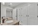Bathroom with granite countertops, double sinks, and ample closet space at 4622 Grovecrest Dr, Lakeland, FL 33813