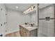 Bathroom features a double sink vanity, granite countertop and modern tiled shower at 4622 Grovecrest Dr, Lakeland, FL 33813