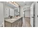 Bathroom with double sinks, granite countertop, and a well-lit mirror at 4622 Grovecrest Dr, Lakeland, FL 33813