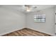 Empty bedroom features wooden floors, a ceiling fan, and a window at 4622 Grovecrest Dr, Lakeland, FL 33813
