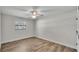 Empty bedroom features wooden floors, ceiling fan, and a window at 4622 Grovecrest Dr, Lakeland, FL 33813