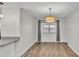 Cozy dining room with pendant lighting, wood-look tile floors, and natural lighting at 4622 Grovecrest Dr, Lakeland, FL 33813