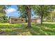 Exterior view featuring a landscaped front yard with healthy green grass and shade trees at 4622 Grovecrest Dr, Lakeland, FL 33813