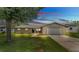 Charming single-story home with a two-car garage and a beautifully landscaped front yard at 4622 Grovecrest Dr, Lakeland, FL 33813