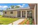 Charming covered front porch with stylish columns, beautiful landscaping, and a welcoming entrance at 4622 Grovecrest Dr, Lakeland, FL 33813