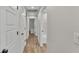 Bright hallway with wooden floors and white doors provides access to multiple rooms at 4622 Grovecrest Dr, Lakeland, FL 33813