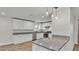Modern kitchen with white cabinets, granite countertops, stainless steel appliances, and stylish pendant lighting at 4622 Grovecrest Dr, Lakeland, FL 33813