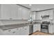Bright kitchen features granite countertops, stainless appliances, and white cabinets at 4622 Grovecrest Dr, Lakeland, FL 33813