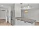 Open-concept kitchen featuring an island with granite countertop, stainless steel appliances, and ample cabinet space at 4622 Grovecrest Dr, Lakeland, FL 33813