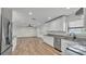 Open-concept kitchen and living area with granite countertops and stainless steel appliances at 4622 Grovecrest Dr, Lakeland, FL 33813