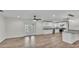 Bright and open living space featuring wood-look tile floors, a modern kitchen, and access to the backyard at 4622 Grovecrest Dr, Lakeland, FL 33813
