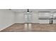 Expansive living area showcasing wood-look tile flooring, a contemporary kitchen, and bright natural light at 4622 Grovecrest Dr, Lakeland, FL 33813