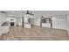 Spacious open-concept living area with wood-look tile flooring, ceiling fans, and abundant natural light at 4622 Grovecrest Dr, Lakeland, FL 33813