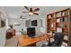 Well-lit office space with a wooden desk, bookcase, and comfortable black chair at 4622 Grovecrest Dr, Lakeland, FL 33813