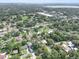 A bird's eye view of the home nestled among trees in a residential area with nearby amenities at 504 Prado Pl, Lakeland, FL 33803