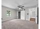 Neutral bedroom featuring new carpet, a modern ceiling fan, and sliding barn closet doors at 504 Prado Pl, Lakeland, FL 33803