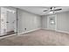 Spacious carpeted bedroom featuring a ceiling fan and white trim and doors at 504 Prado Pl, Lakeland, FL 33803