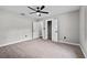 Large carpeted bedroom with a ceiling fan, closet and bright window with outside views at 504 Prado Pl, Lakeland, FL 33803