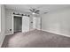 Large carpeted bedroom with a modern ceiling fan, closet, and bright window at 504 Prado Pl, Lakeland, FL 33803