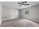Spacious carpeted bedroom with a ceiling fan and a window providing natural light at 504 Prado Pl, Lakeland, FL 33803
