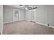 Carpeted bedroom featuring a ceiling fan and glass doors to the backyard at 504 Prado Pl, Lakeland, FL 33803