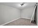 Clean carpeted bedroom featuring neutral paint and white trim; tall ladder stored on the side at 504 Prado Pl, Lakeland, FL 33803