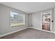 Large carpeted bedroom with bright window and views to kitchen and dining area at 504 Prado Pl, Lakeland, FL 33803