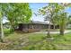 Charming single-story home with a screened porch and mature landscaping in a quiet neighborhood at 504 Prado Pl, Lakeland, FL 33803