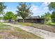Inviting single-Gathering home featuring a long driveway and a cozy screened-in front porch at 504 Prado Pl, Lakeland, FL 33803