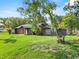 Single-story home with gray siding, a well-manicured front lawn, and mature trees at 504 Prado Pl, Lakeland, FL 33803