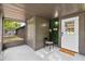 Inviting front porch featuring a chair, storage room and a door with stylish features at 504 Prado Pl, Lakeland, FL 33803